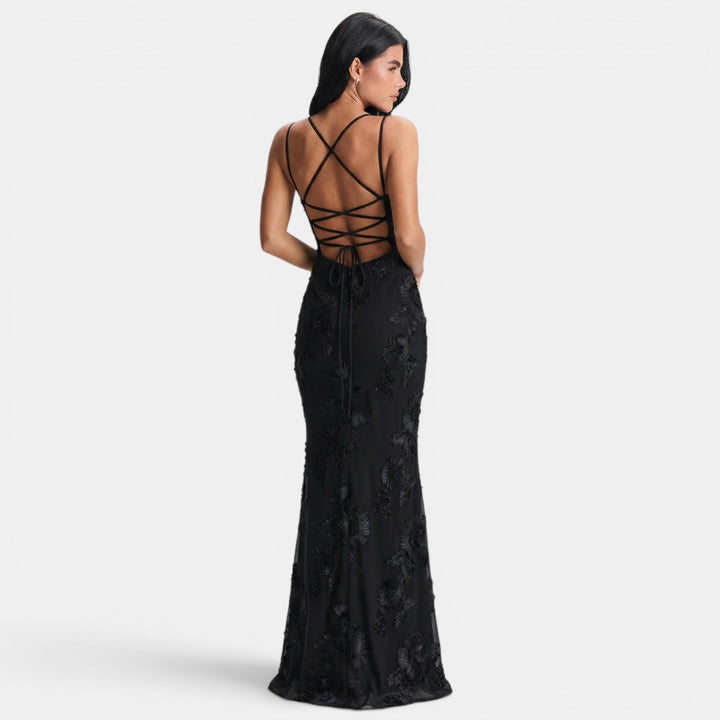 Black lace maxi evening dress with open-back design and flowing floor-length skirt