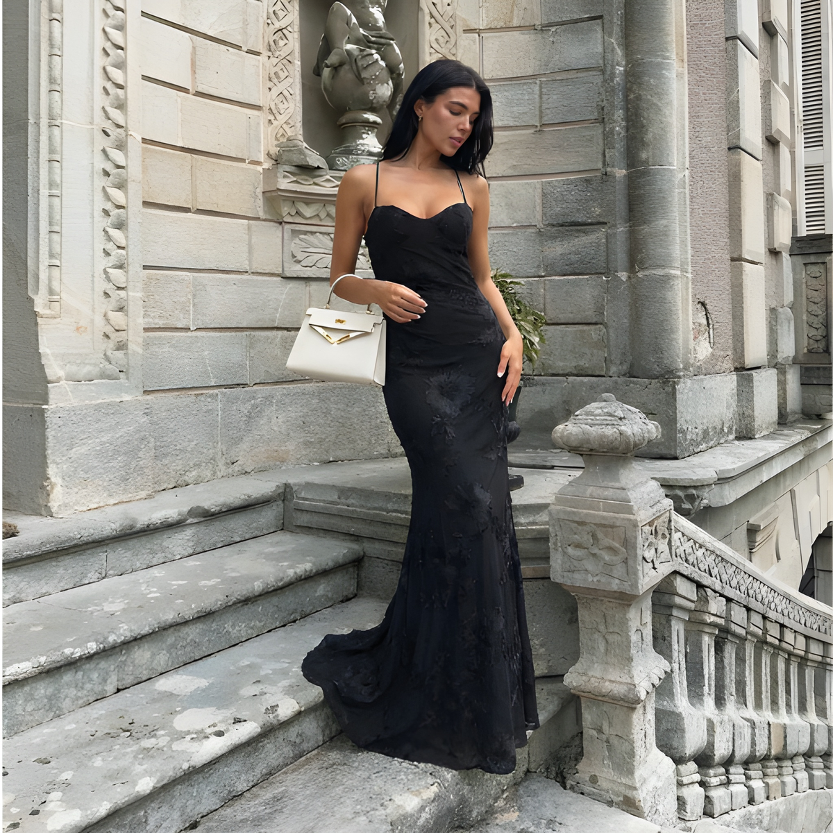 Black lace maxi evening dress with open-back design and flowing floor-length skirt