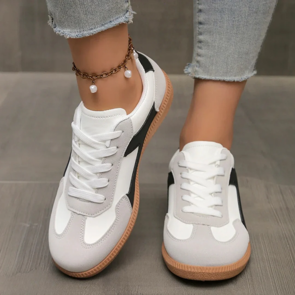 Women's low-top lace-up sneakers with paneled upper and contrast outsole